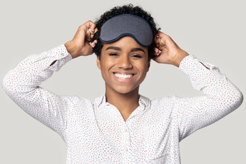 Happy black girl laugh wearing grey sleeping mask on head