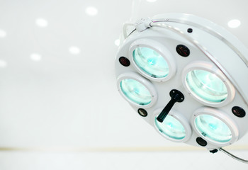 Surgical lamp close-up on the background of a modern operating room in the clinic. Copy space. Your text. Medical concept.