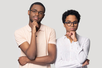 Pensive ethnic couple in glasses thinking making decision