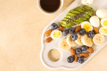 Avocado, quail eggs, banana, blueberry and almond. Ketogenic diet. breakfast