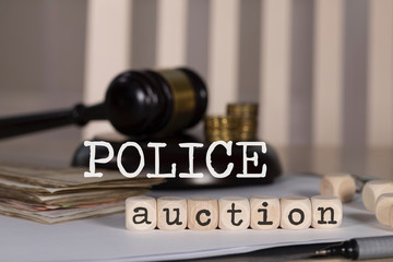 Word POLICE AUCTION composed of wooden dices.