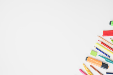 Fototapeta premium Colorful school accessories on corner of the white background