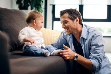 Obraz premium Happy father bonding with his small son at home.
