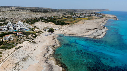 Obraz premium The rocky coast of Cyprus with azure water near Ayia Napa. Flying drone over the sea