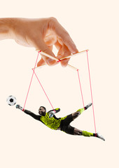 Man like a puppet in somebodies hands on yellow background. Concept of unfair manipulation,...