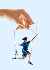 Man like a puppet in somebodies hands on blue background. Concept of unfair manipulation, phycology...