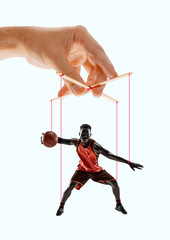Man like a puppet in somebodies hands on blue background. Concept of unfair manipulation, phycology...
