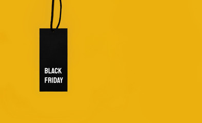 Sale tag with Black Friday inscription on yellow background.