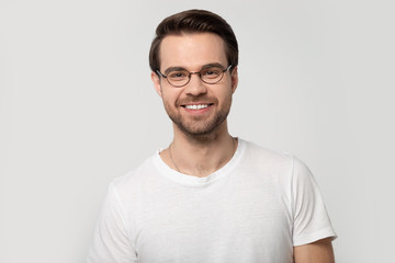 Headshot portrait smiling man wearing glasses isolated on grey background