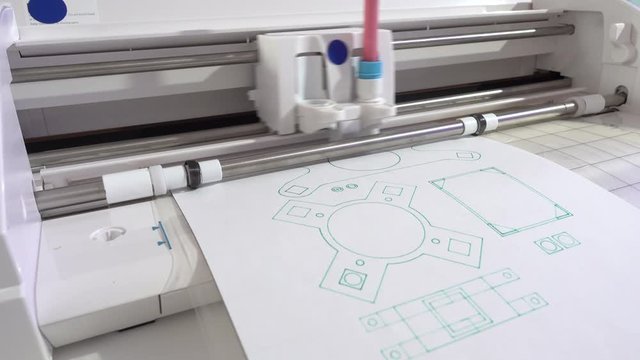 A drawing plotter draws a schematic of industrial details. Device design