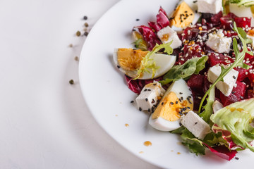 Fresh mixed salad in a bowl on a white background