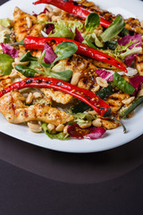 Mexican salad with hot pepper chiken fillet lettuce on plate
