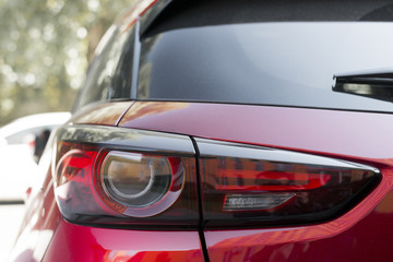 Stylish rear light on new red automobile