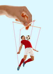 Man like a puppet in somebodies hands on blue background. Concept of unfair manipulation, phycology...