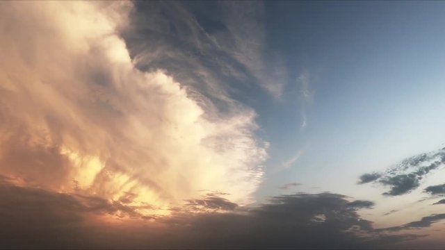 Colorful dramatic sky with clouds at sunset. Twilight sky background, slow motion.