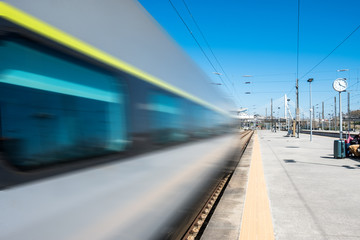 Fototapeta na wymiar Beautiful railway station with moving modern commuter train at sunny day. Railroad outdoor platform