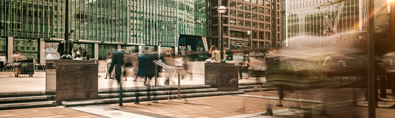 Canary Wharf plaza in central London at sunrise with commuters travelling to work panoramic  © Studio-FI