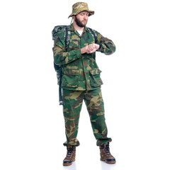Man in camouflage clothes with backpack hiking standing looking on white background isolation