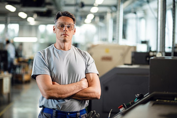 Portrait of confident CNC machine operator in a factory.
