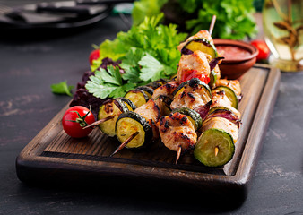 Grilled meat skewers, chicken  shish kebab with zucchini, tomatoes and red onions. Barbecue food.