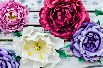 bouquet of craft flowers lying on the wooden table