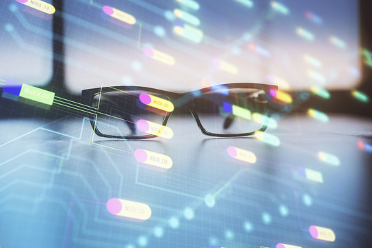 Data tech hologram with glasses on the table background. Concept of technology. Double exposure.