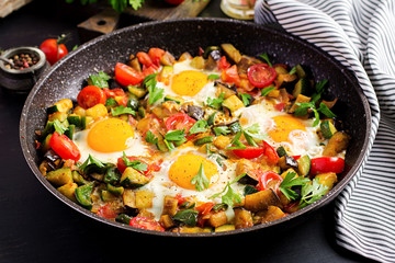Late breakfast - fried eggs with vegetables. Shakshuka. Arabic cuisine. Kosher food.