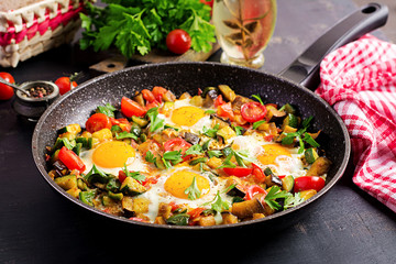 Late breakfast - fried eggs with vegetables. Shakshuka. Arabic cuisine. Kosher food.