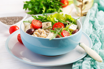 Vegan salad. Breakfast bowl with oatmeal, tomatoes, cheese, lettuce,  and olives. Healthy food. Vegetarian buddha bowl.