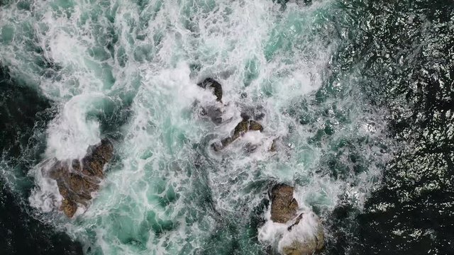 sea waves crashing against a rocky shore top view from the drone, background