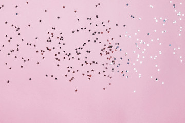 Star shaped confetti on pastel pink background