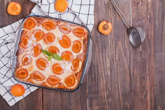 Delicious homemade cke with apricots and cottage cheese on the wooden background