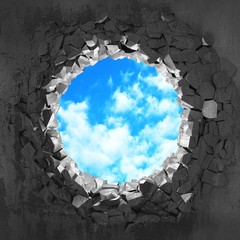 Сracked broken hole in concrete wall to cloudy sky