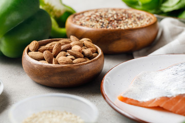 selective focus of nuts in bowl near salmon, ketogenic diet menu