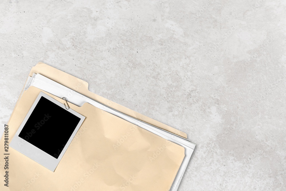 Poster file folder with documents and blank polaroid