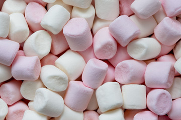 Background of pink and white mini marshmallows from above.