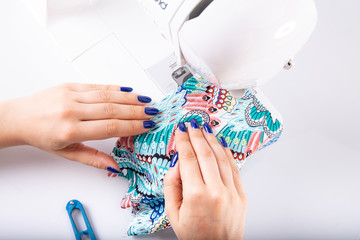 Sewing. The woman sews on the machine