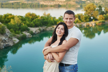 Family travel on vacation near lake in summer. Tourist enjoying on vacation. Relax on lake. Summer vacation.  Camping, picnic near lake.Romantic date on background of landscape.Couple in love