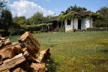 Fototapeta premium Bulgarian cottage with logs chopped and prepared for winter