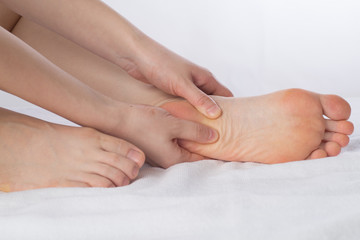 Obraz na płótnie Canvas Close-up of female hands doing foot massage