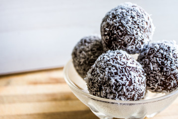  chocolate balls in coconut chips background