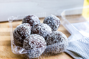  chocolate balls in coconut chips background
