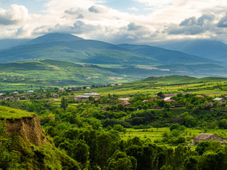 Fototapeta na wymiar Georgian landscape with village standing at the bank of Ksani river.