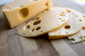 piece of cheese on wooden board