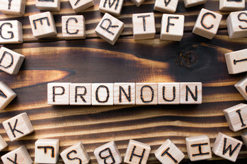 word pronoun composed of wooden cubes with letters, Part of speech concept scattered around the...
