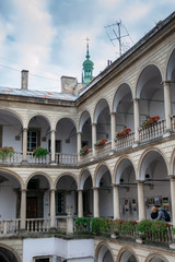 Young couple holding each other in Italian Courtyard in Lviv