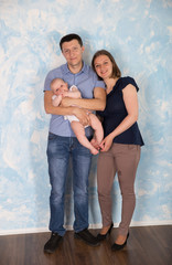 Happy Young Caucasian Family Posing in Studio