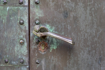 Bronze door handle on a portal entrance to a chapel