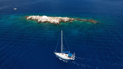 Aerial drone photo of small picturesque chapel of Agios Nikolaos built in small islet near picturesque main town of Hydra or Ydra island, Saronic gulf, Greece