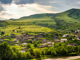 Small Georgian village standing at the bank of Ksani river in evening